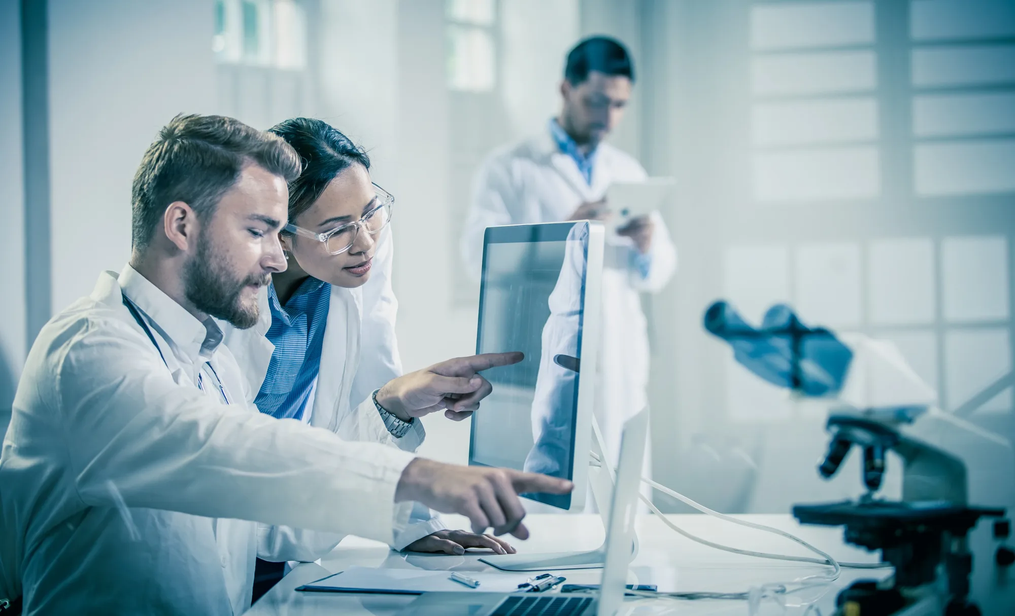 AK Medical engineers reviewing 3D-printed titanium implant designs